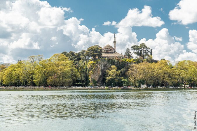 The mosque sits on top of cliffs overlooking Lake Panvotida. As seen from the boat going out to the island. (Ap23)