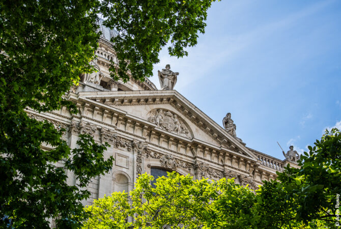 A glimpse between the trees of the pediment over the north transept of St Paul's with the dome high above. (May17)
