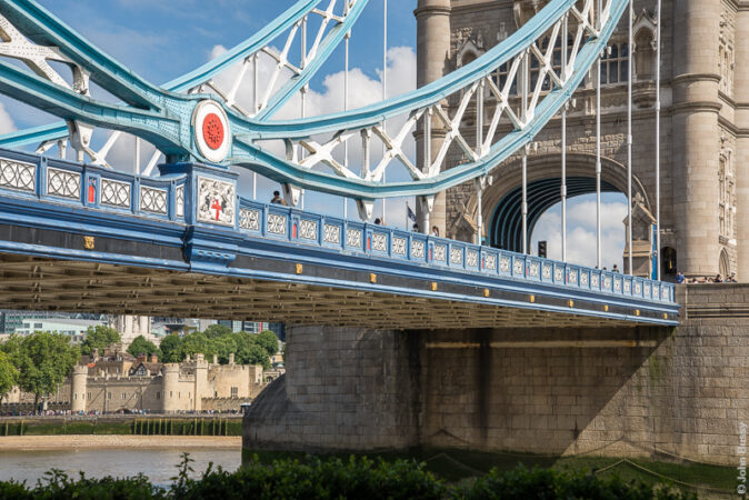 Part of the Tower of London is visible on the other side of the Thames, under the southern approach to Tower Bridge. (July16)