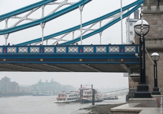A misty view under Tower Bridge towards Butlers Wharf Pier at low tide. (Mar18)